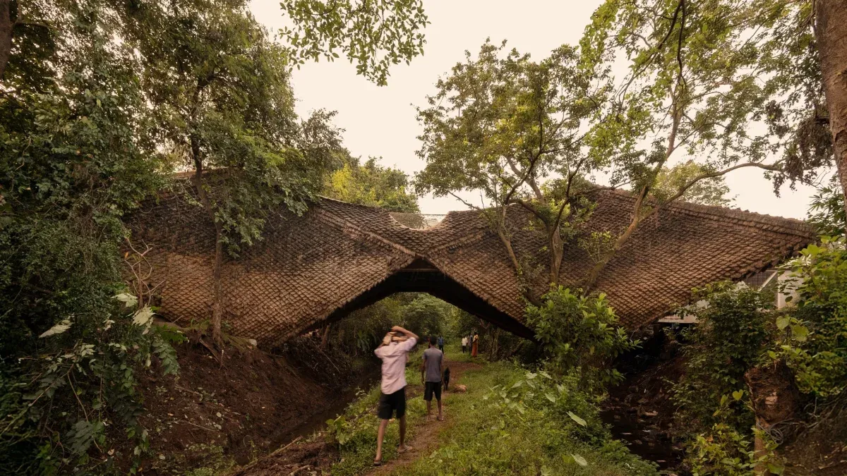 Habitable bridge spans 100 feet over two streams in rural India