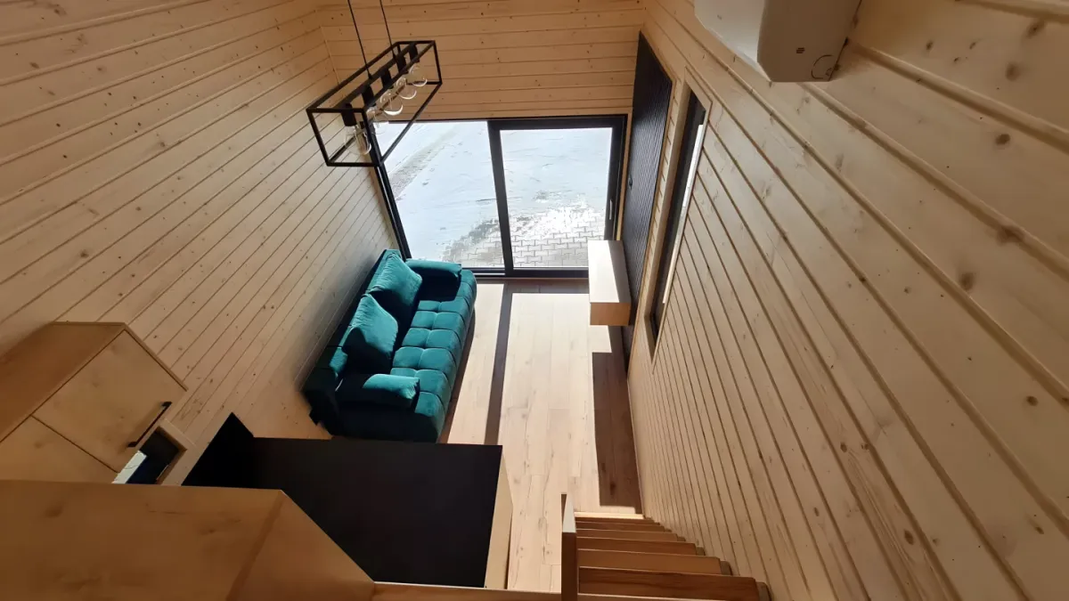 The Samuel tiny house features a spacious light-filled interior with a high ceiling