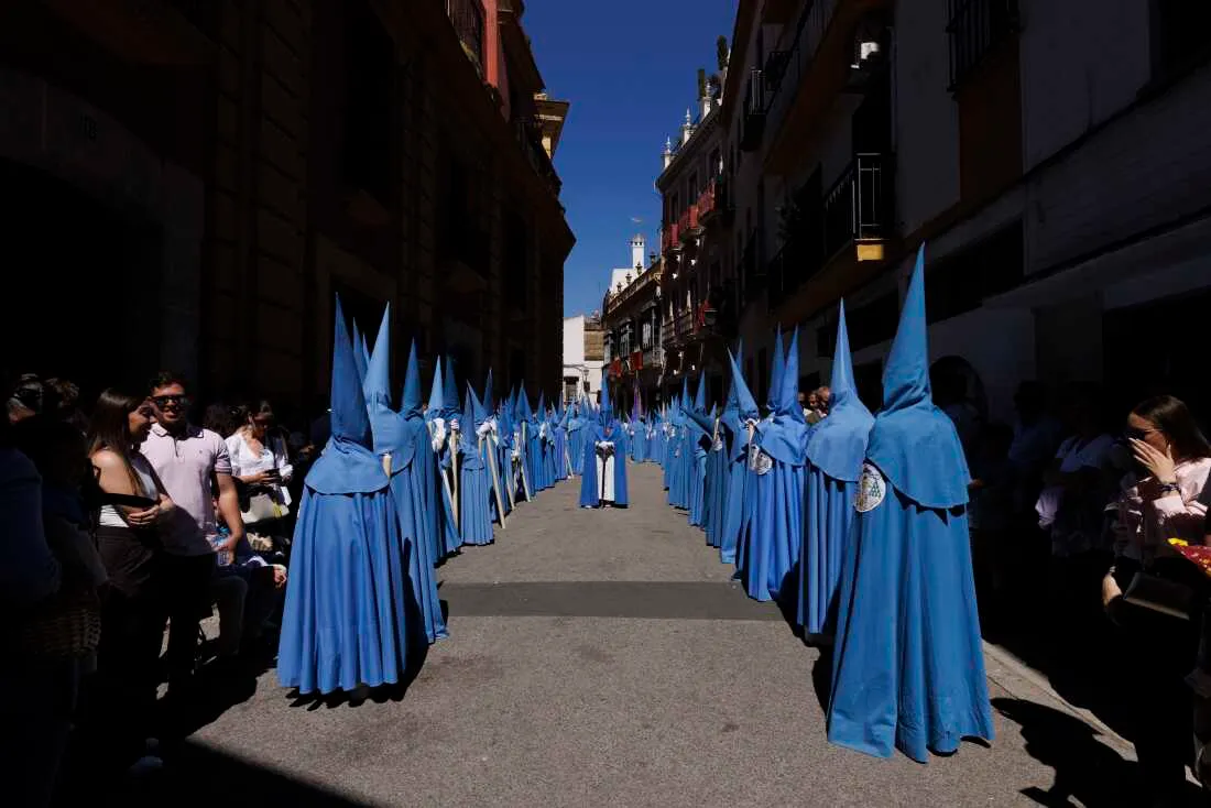 Penitents of San Esteban brotherhood take part in a procession during Holy Week (Semana Santa) observances
