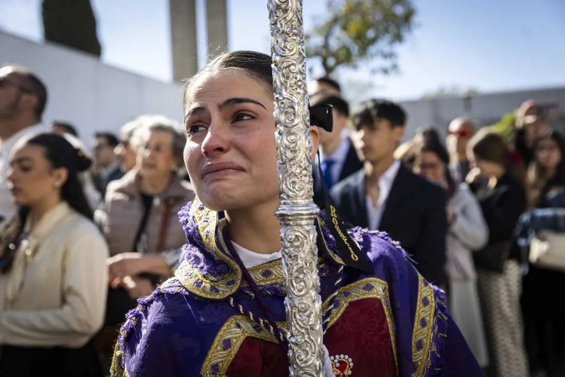 A girl from the brotherhood of âCautivo y Rescatadoâ known as âSan Pabloâ, cries as she begins her procession to the Cathedral of Seville