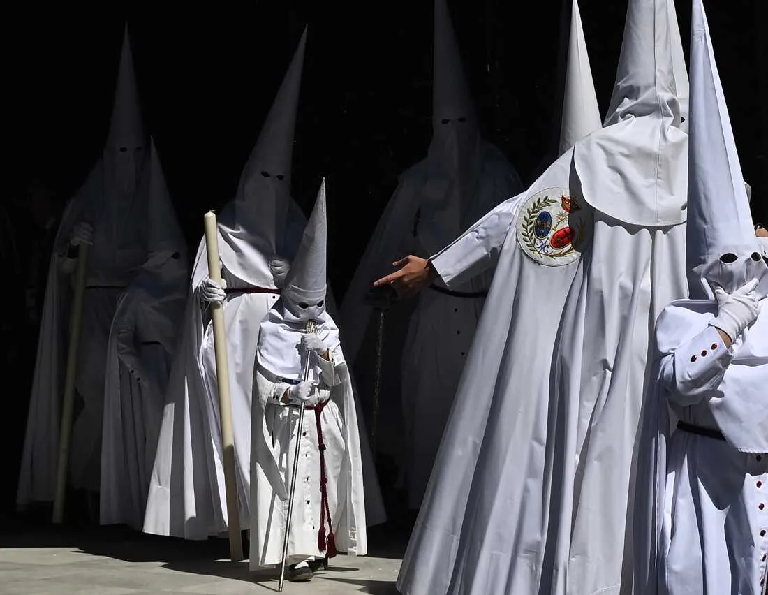 Penitents from the La Paz brotherhood parade in the Palm Sunday procession in Seville on March 29, 2026.