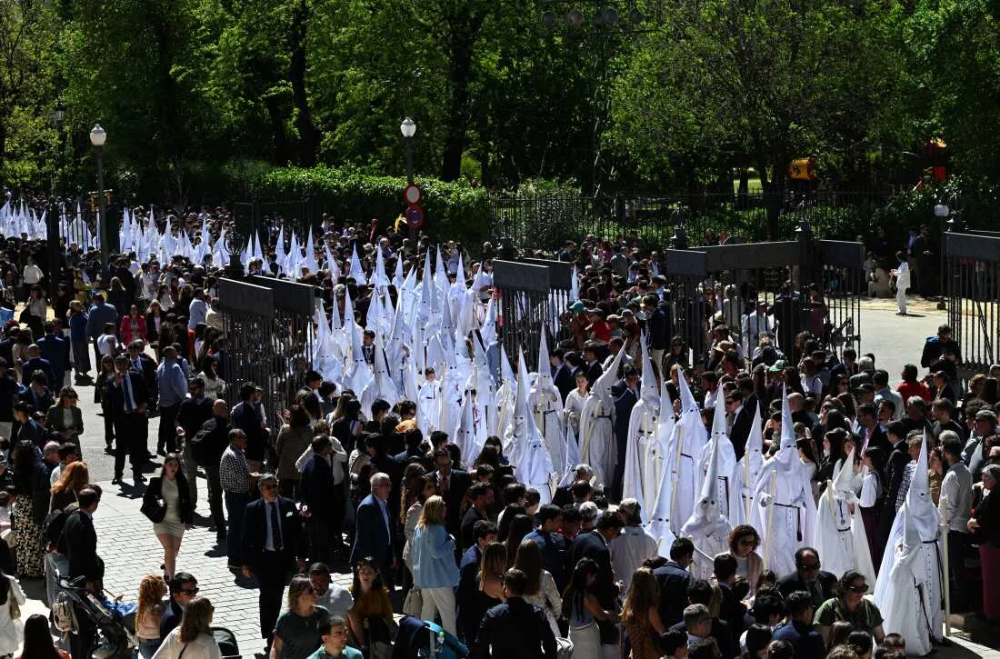 Penitents from the La Paz brotherhood parade in the Palm Sunday procession in Seville on March 29, 2026.