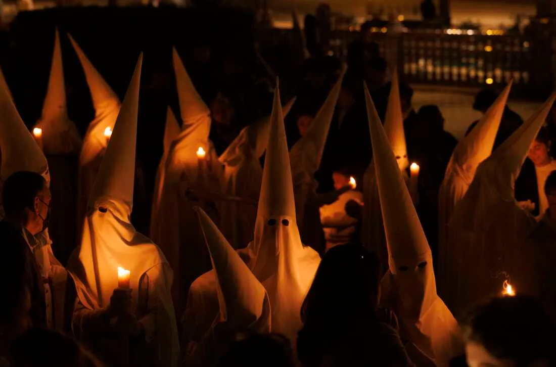 Penitents of La Paz (The Peace) brotherhood take part in a procession during Holy Week (Semana Santa) observances on March 29, 2026 in Seville, Spain.