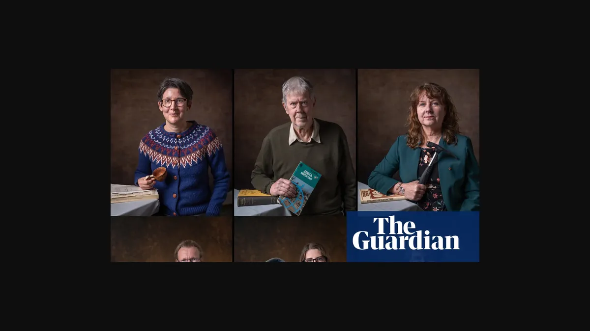 A man rests his hand on a microscope. A book lies on the base of the microscope