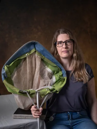 A woman holds a large net