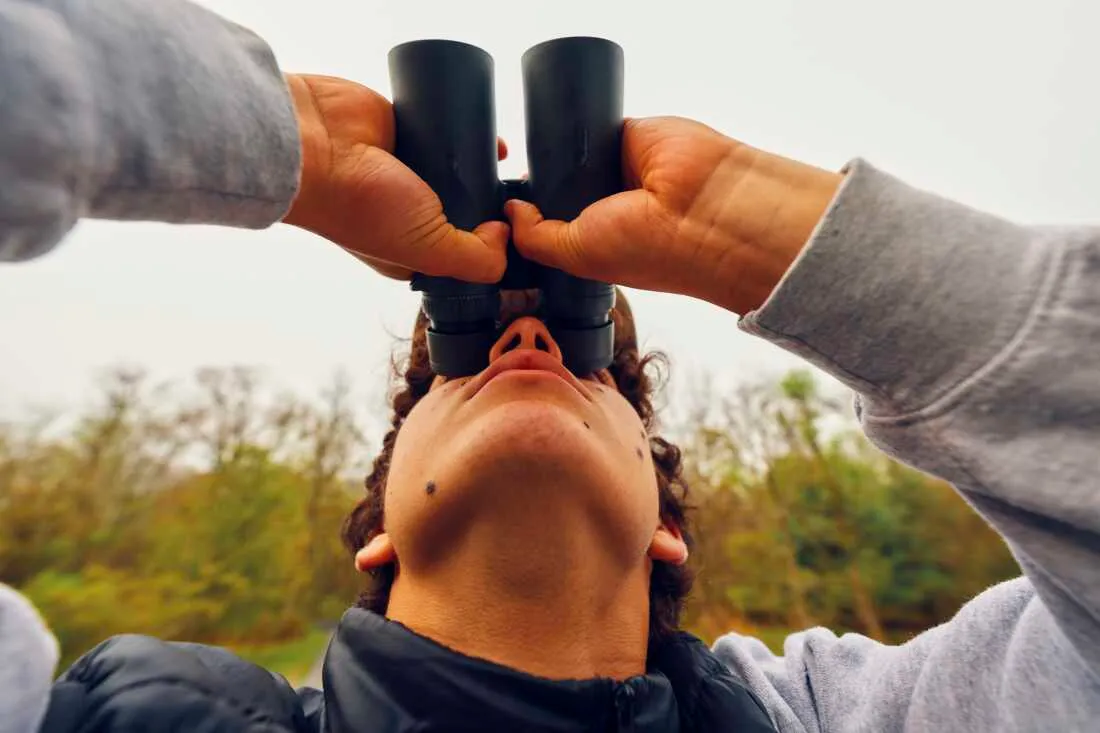 Zade Pacetti, 16, looks through binoculars.