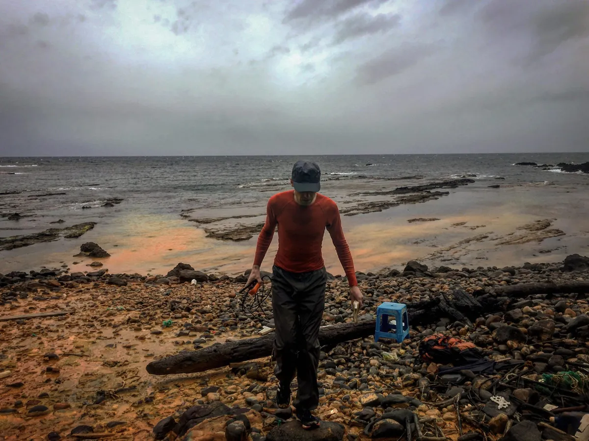 A picture of the Sea of Japan as seen from one of five hot springs, where Shawn E. McGlynn is conducting sampling. Orange discharge of oxidated spring water can be seen flowing into the sea