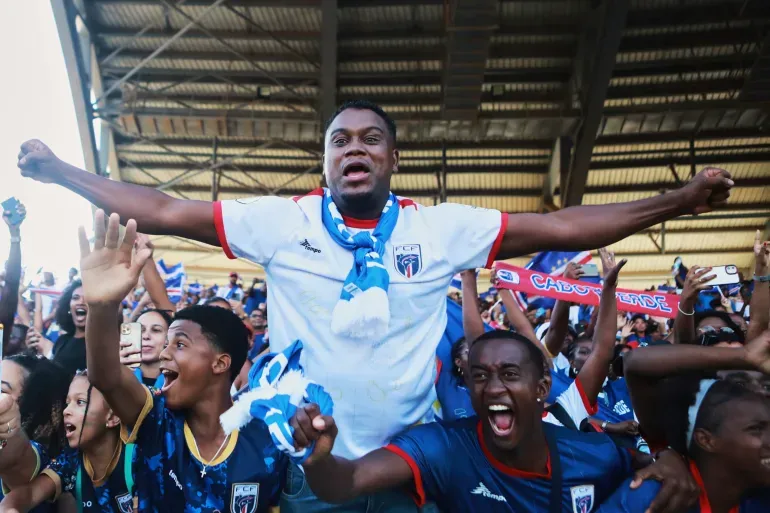 Fans celebrate in the stands after Cape Verde defeated Eswatini in a World Cup qualifying soccer match at Estádio Nacional in Praia, Cape Verde, Monday, Oct. 13, 2025, to clinch their qualification for the 2026 World Cup.
