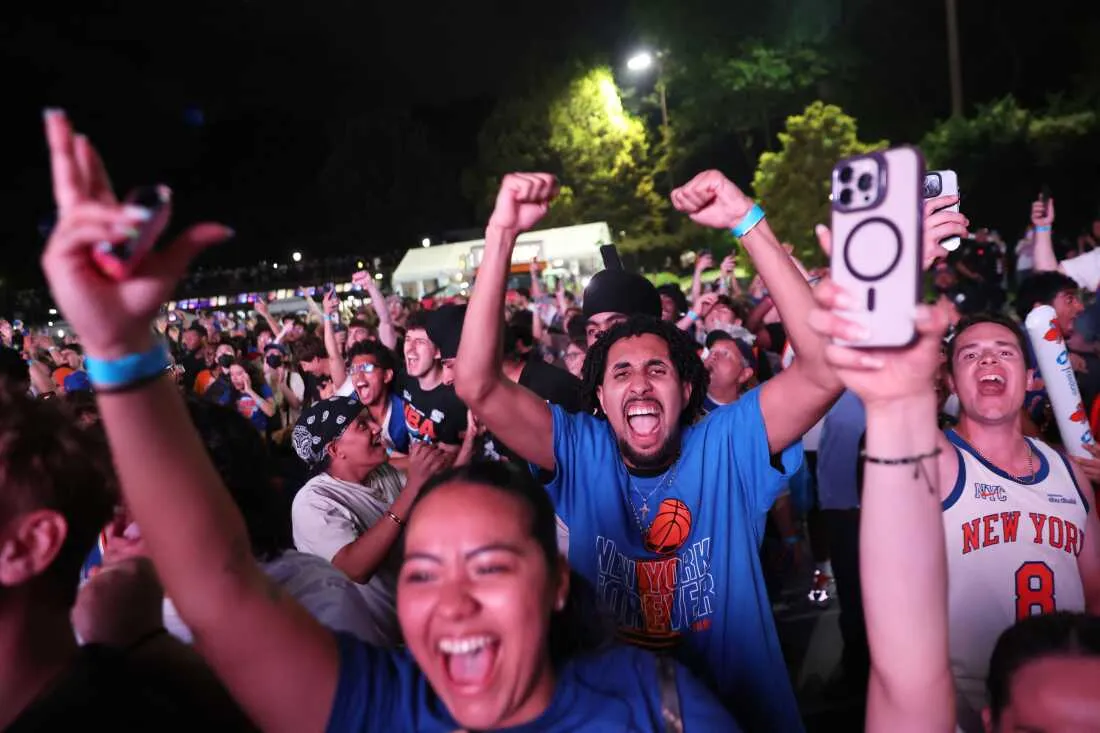 New York Knicks fans celebrate during a watch party inside Central Park during Game 4 of the NBA Finals basketball series between the Knicks and the San Antonio Spurs, Wednesday, June 10, 2026, in New York.