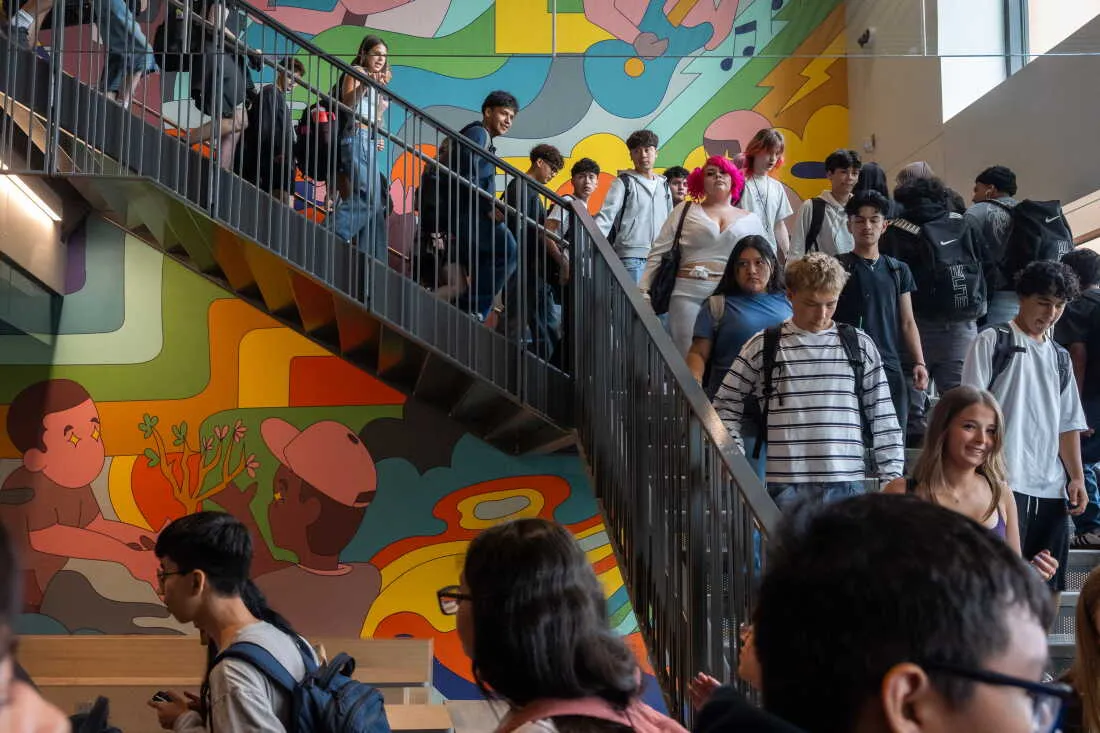 Students walk past a new mural to their next class at the newly rebuilt Beaverton High School.