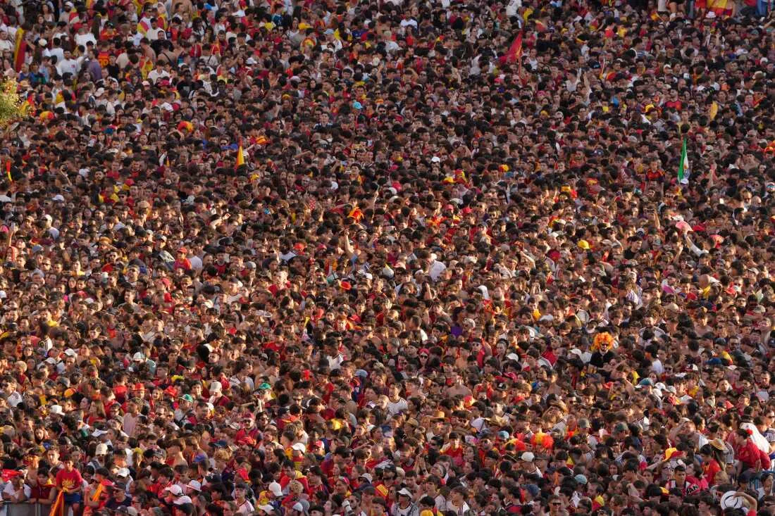 Fans crowd together as they wait for the arrival of players from Spain's national soccer team in Madrid on Monday, July 20, 2026, after Spain defeated Argentina in the World Cup final in East Rutherford, N.J., near New York.