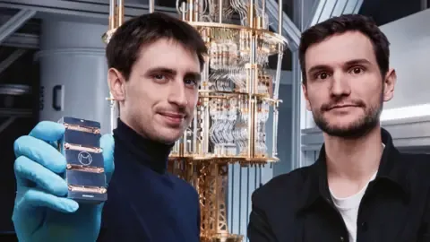 Théau Peronnin holds one of his company's computer chips and stands next to co-founder Raphaël Lescanne.