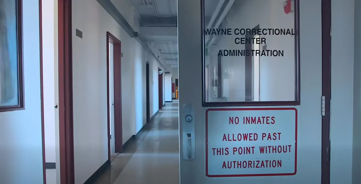 A door into a prison that reads Wayne Correction Center Administration: No Inmates Allowed Past This Point Without Authorization