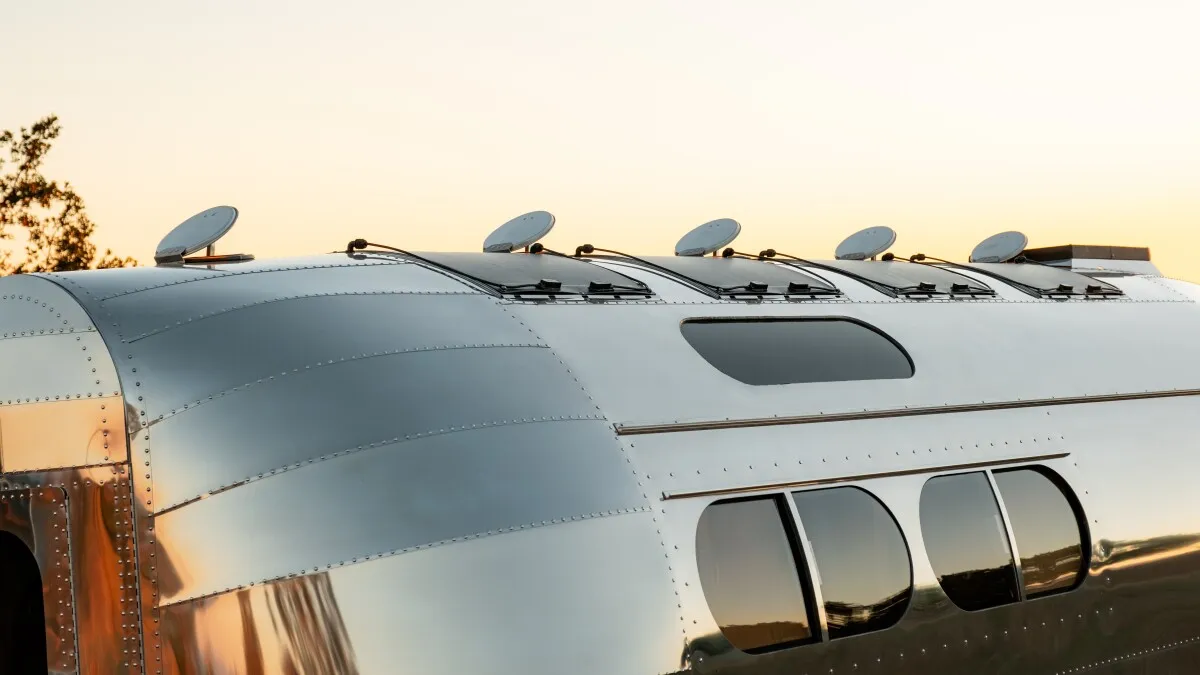 Frontier-smashing camper hides rustic lodge inside shimmering shell