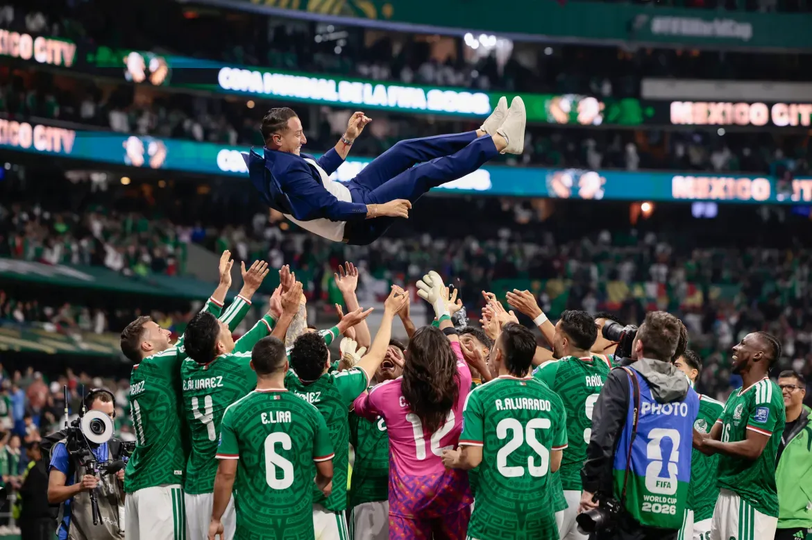 Mexican players celebrate winning the Round of 32 match against Ecuador in Mexico City.