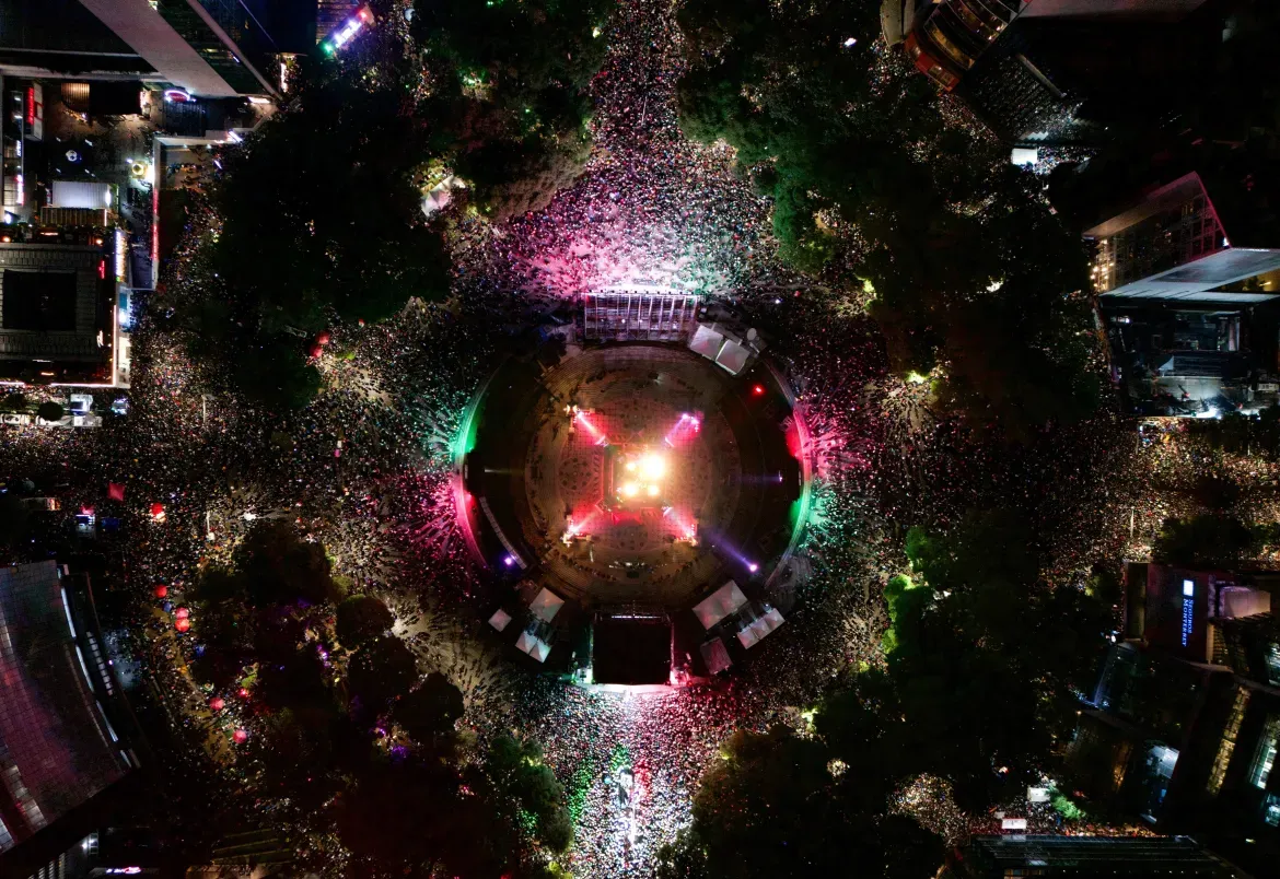 An aerial photograph shows Mexican football fans celebrating their victory over Ecuador at the Angel of Independence in Mexico City.
