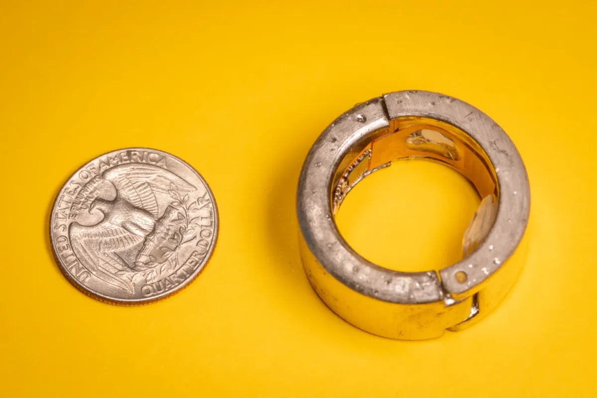 The biomarker monitoring ring next to a US quarter for scale
