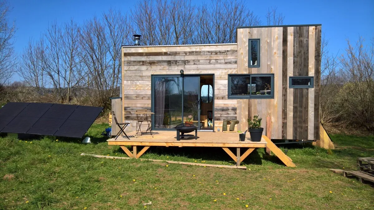 Tiny house with solar panels and wind turbine proves off-grid living works