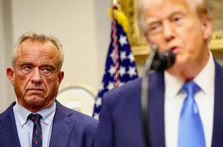 Robert F. Kennedy Jr. looks at Donald Trump while he makes an announcement