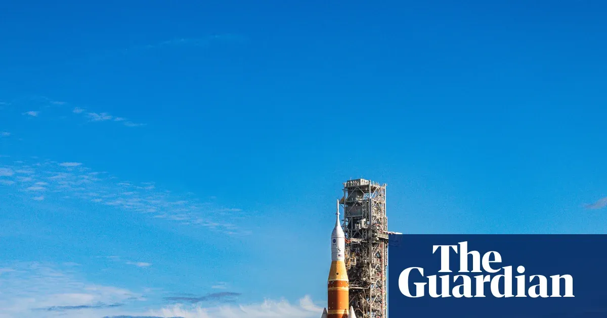 Nasa moon rocket creeps to its launchpad in preparation for astronaut flight