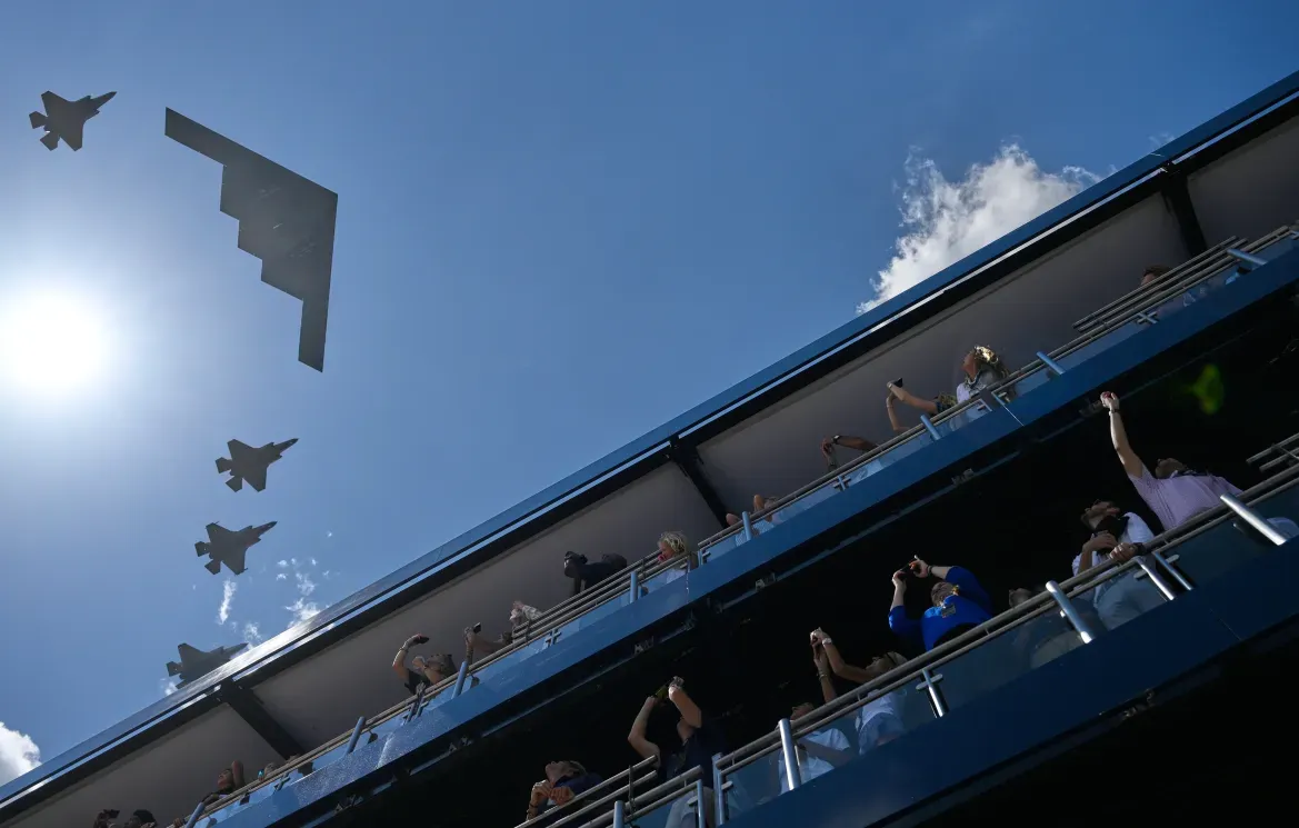 IndyCar fans watch a military flyover before the IndyCar Freedom 250 Grand Prix.