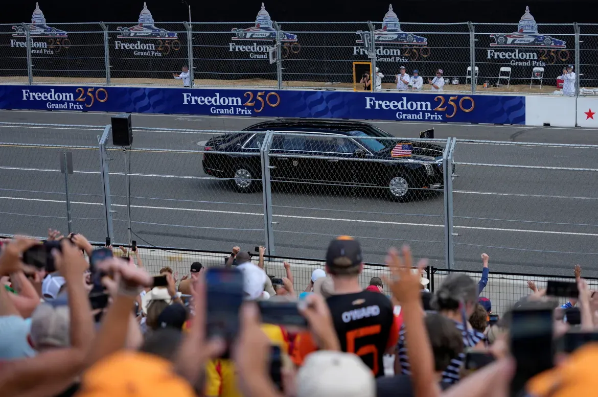 US President Donald Trump rides in the presidential limousine before the start of the race.