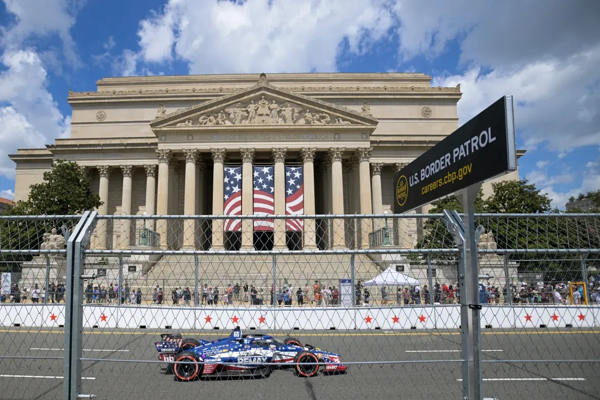 Driver Marcus Armstrong rides past the National Archives.