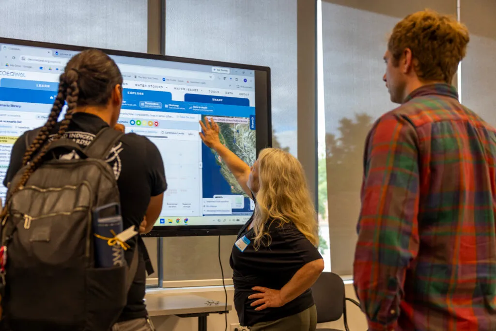 Attendees of the COEQWAL launch event on Sept. 3 demo the new website on large touch screen displays.