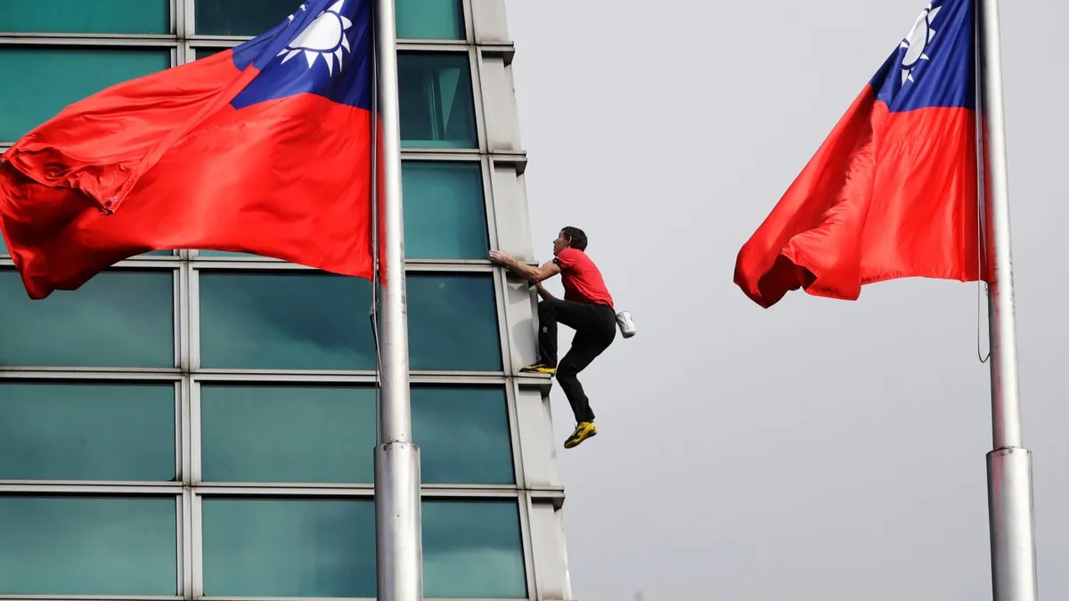 U.S. rock climber Alex Honnold reaches top of Taipei 101 skyscraper without ropes