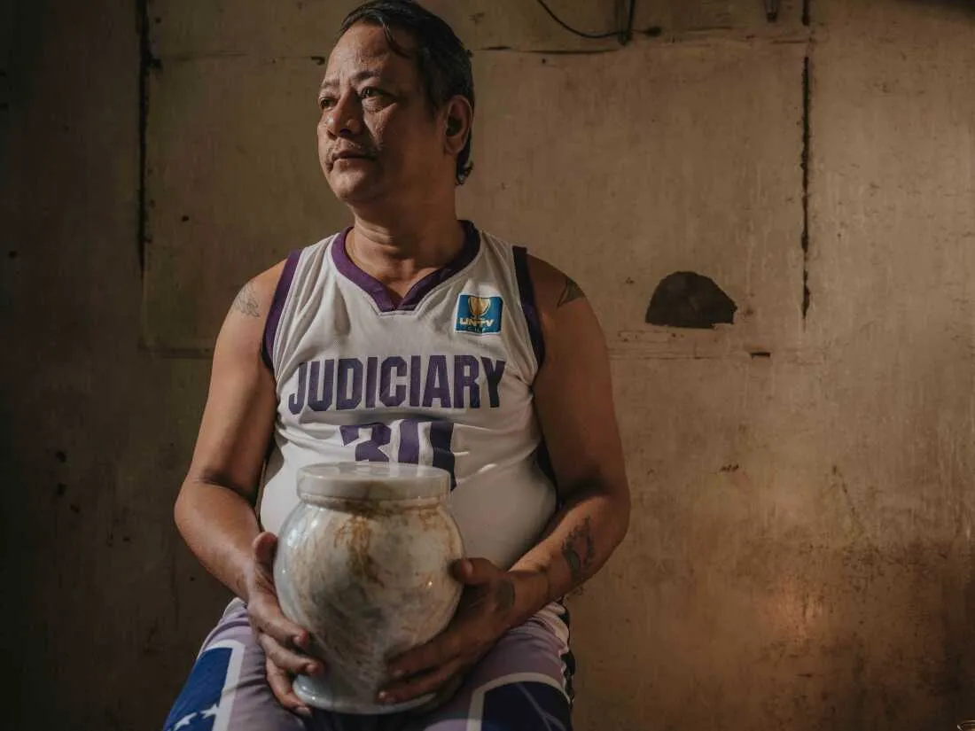 February 25, 2025. Quezon City, Philippines. Caballero holds the urn containing the ashes of his mother, Erma R. Caballero, in a quiet moment of remembrance.
The funeral service, provided free of charge by the Mayor of Quezon City, is part of a local initiative aimed at supporting families who cannot afford funeral expenses. This program offers dignified services to those in need, ensuring that no one is denied a proper farewell for their loved ones due to financial hardship.
Photo Credit: Juan Arredondo.
