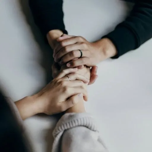 A person's hand holding another person's hand