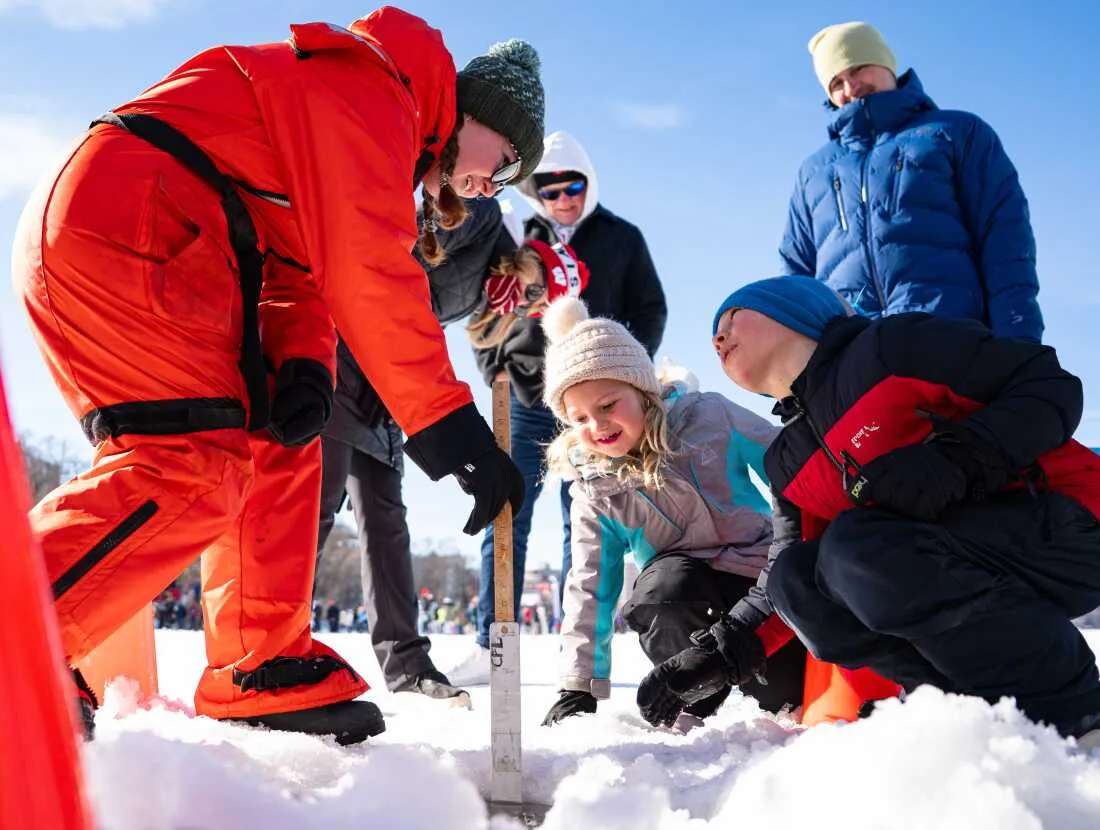 Lincoln Haldeman (right) and his sister Piper (center) measure ice thickness with Helen Schlimm (left), a researcher at UW-Madison's Center for Limnology, during a science demonstration at the annual Frozen Assets Festival on Lake Mendota on Saturday, Feb. 7.