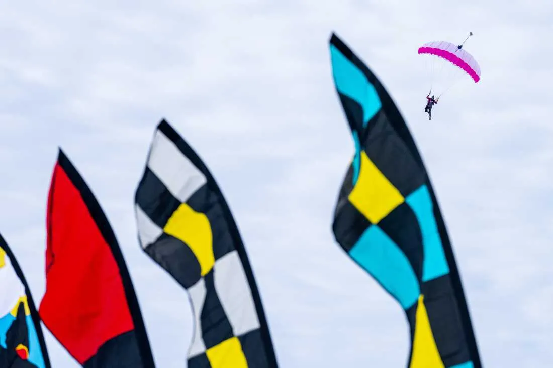 A skydiver glides through the air during the Frozen Assets Festival above Lake Mendota and Madison, Wis., on Saturday, Feb. 7.