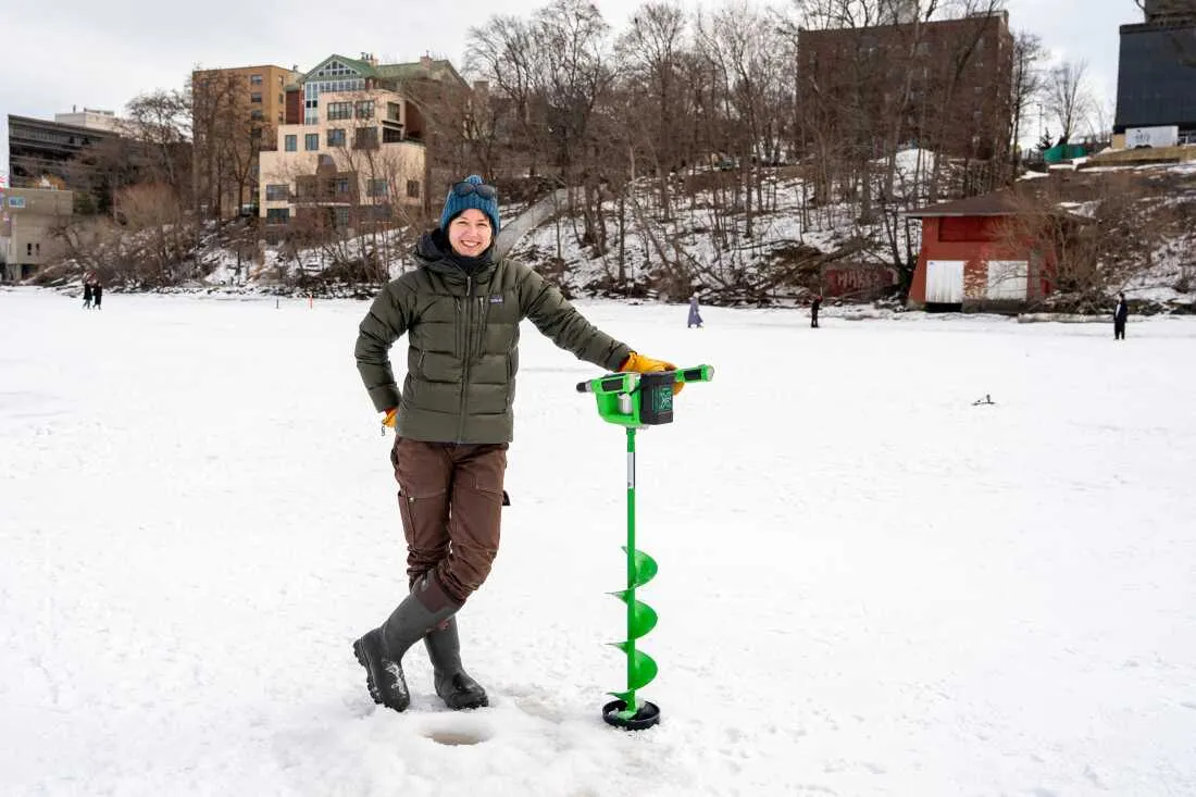 Hilary Dugan, a limnologist at the University of Wisconsin, Madison, poses for a portrait behind a hole she drilled on Lake Mendota during the city's annual Frozen Assets Festival on Feb. 7.