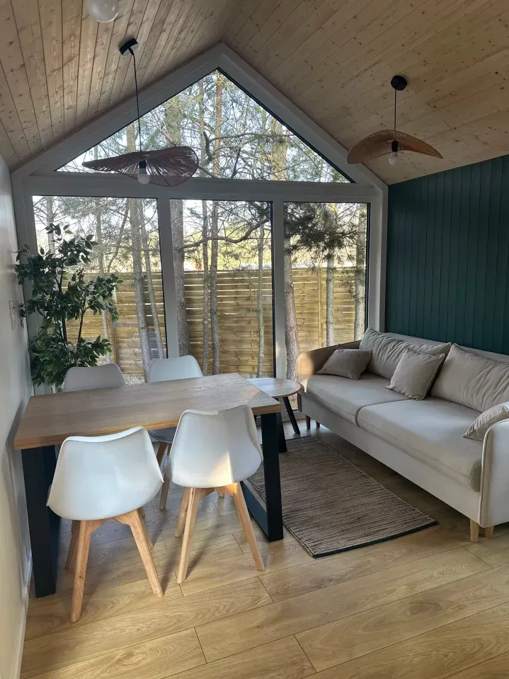The Sky tiny house features a spacious living room with a high ceiling and generous glazing