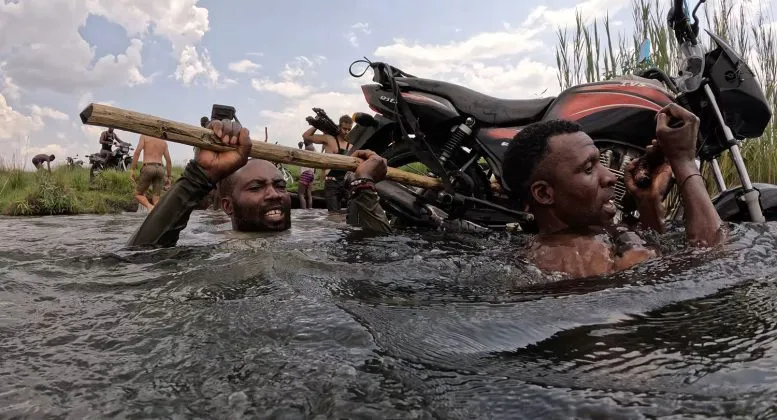 Luchazi Tribal Hunters Carry a Motorcycle