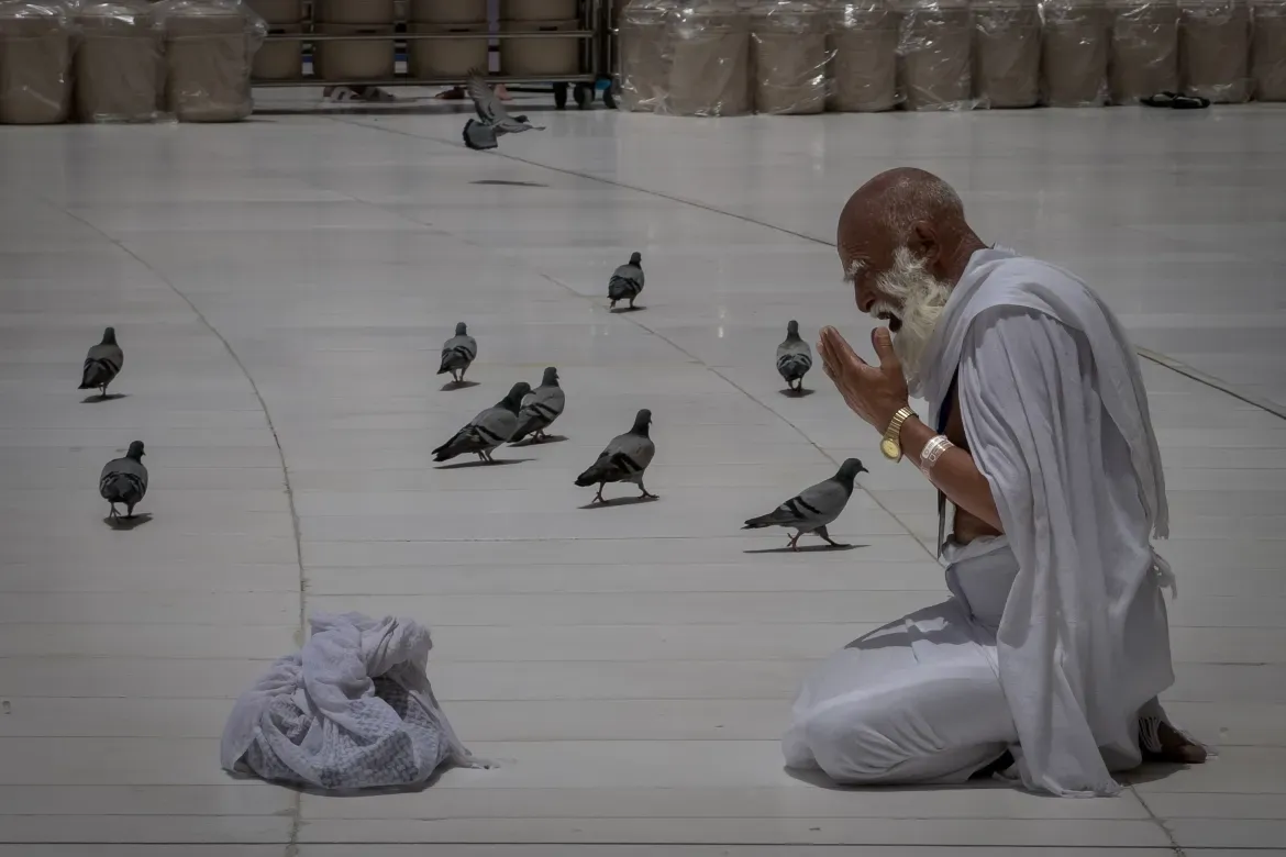 A Muslim pilgrim prays in front of the Kaaba.