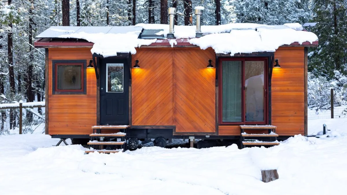 This tiny office on wheels fits two workspaces and a hidden bed