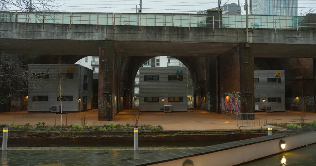 First-of-its-kind homeless village built under a bridge opens in Manchester