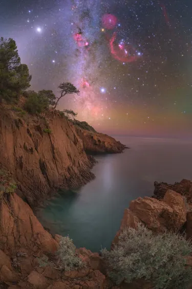 Celestial light over sea cliffs in the south of France. The night sky takes on a distinctly different character during this time of year, especially with the arrival of the winter constellations