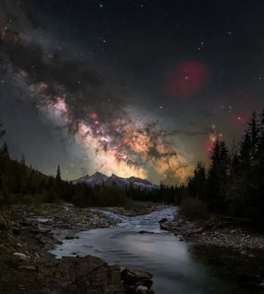 Milky Way Over Tatra Mountains: This image is taken in the Białka Gorge in Jurgów, Poland. In the foreground, the river creates a natural leading line, guiding the eye from the earth toward the mountains and into the night sky, visually connecting the terrestrial and the cosmic